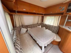 a small dining room with a table in an rv at Lazy Days Caravan in Berlin