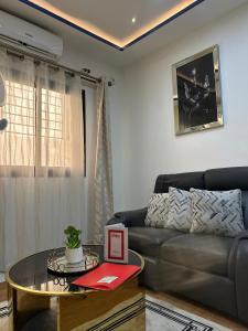a living room with a couch and a table at Residence Le Sommet in Douala