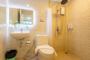 a bathroom with a toilet and a sink at Friend House BKK in Bangkok +34 photos