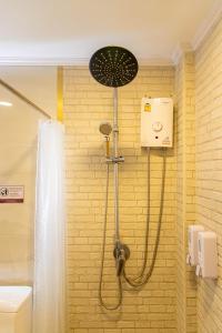 a shower in a bathroom with a shower head at Friend House BKK in Bangkok