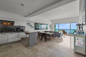 a kitchen and dining room with a view of the ocean at Deck12 Casino and Resort by Monyxbnb in Puerto Vallarta