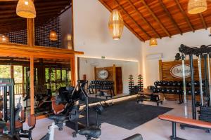 a fitness room with treadmills and exercise equipment at Aketá Hotel Boutique in Trancoso
