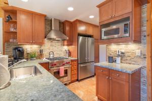a kitchen with wooden cabinets and stainless steel appliances at Jester Court home in Tahoe Vista