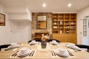 a dining room with a table with chairs and a fireplace at Parking on Cathedral St House, 5min to Finger Wharf & Royal Botanic in Sydney