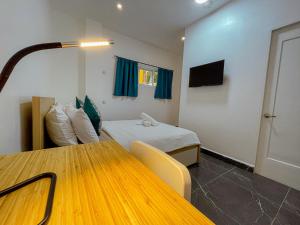 a room with a bed and a table in it at Baydreams in Coron