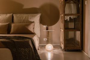a bedroom with a bed and a lamp on the floor at Palazzo Console in Lecce