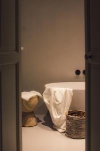 a room with a white table and a basket at Palazzo Console in Lecce