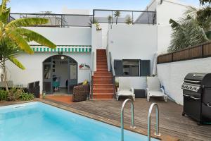 a villa with a swimming pool and a house at Villa Garajau House in Caniço