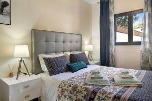 a bedroom with a large bed with pillows on it at Villa Garajau House in Caniço +17 photos