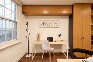an office with a desk with a laptop on it at Parking on Cathedral St House, 5min to Finger Wharf & Royal Botanic in Sydney