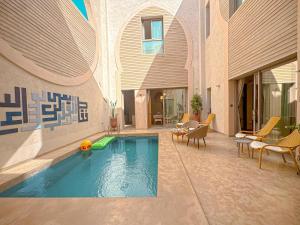 a swimming pool in the middle of a building at Riad Timija in Marrakesh