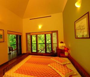 a bedroom with a large bed and a window at Colonel's Retreat, Mavady, Vagamon in Vagamon