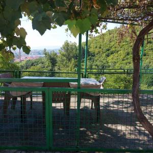 a horse standing next to a table in a cage at Studio Relax in Travnik +3 photos