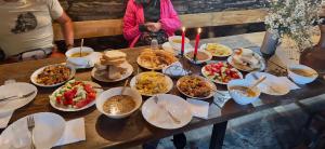 a table with plates of food on top of it at Qaldea Resort in Ushguli