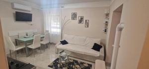 a living room with a couch and a table at Bella Z Apartman in Kaposvár