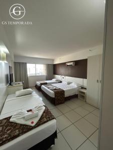 Ένα ή περισσότερα κρεβάτια σε δωμάτιο στο le jardin Suits hotel