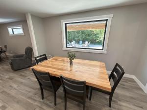 a dining room with a wooden table and chairs at The Farmhouse at Rustic Ridge in Benzonia +31 photos