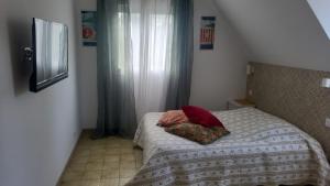 a bedroom with a bed with two pillows on it at Villa Carmen in Touques