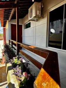 a balcony with benches and flowers on a building at Pousada Sousa Residencial Qrt2 in Sousa +8 photos