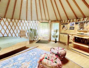 a room with a yurt with a bed and a table at Waterfront CedarGrove Yurt-Glamp in Red Bay