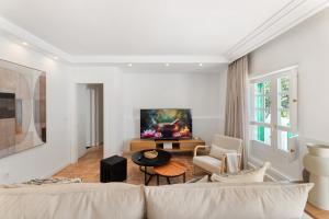 a living room with a couch and a tv at Oasis del Marinero by EscapeHome in Costa Teguise