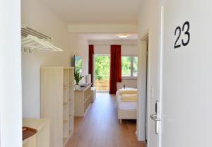 a white bathroom with a sink and a tub at Pension Gambrinus in Passau