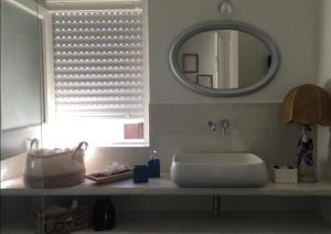 a bathroom with a sink and a mirror at Casa Carmela in Cozze