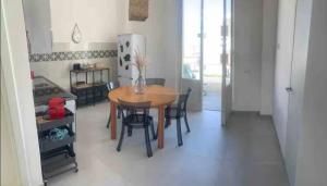 a kitchen and dining room with a table and chairs at Casa Carmela in Cozze +9 photos