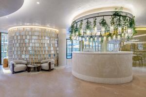a lobby with a waiting room with a reception counter at Hotel Vibra Yamm Urban -New Opening 2025 in San Antonio