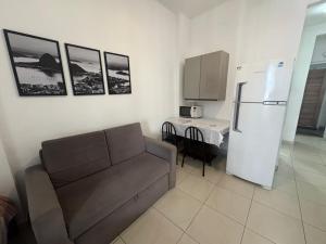 a living room with a couch and a refrigerator at Studio completo ENTRADA pela PRAIA DE COPACABANA, com ar, wifi, netflix, até 4 pessoas, pauloangerami AA3806 in Copacabana