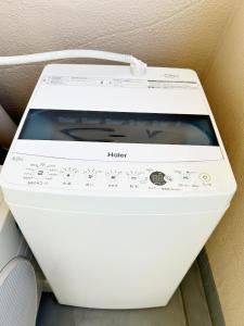 a white washing machine sitting on a shelf at Ikebukuro center#池袋中心#高级阳光公寓车站步行5分#高速wifi#智能马桶干湿分离1201 in Tokyo