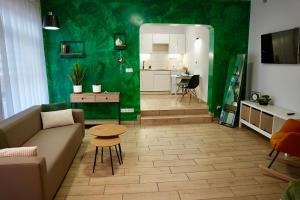 a living room with a couch and a table at Apartament Murowa in Tuchola