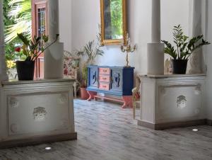 a room with a blue cabinet and potted plants at Portrait Boutique Guesthouse in Valencia