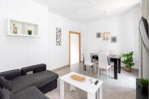 a living room with a couch and a table at Nest Flats Granada in Granada +20 photos