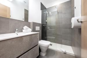 a bathroom with a toilet and a sink and a shower at Nest Flats Granada in Granada