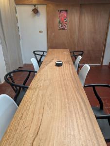 a long wooden table with chairs in a room at Don Jiménez Guesthouse in Puerto Jiménez +100 photos