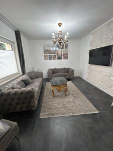 a living room with a couch and a table at Ferienwohnung Gladbeck in Gladbeck
