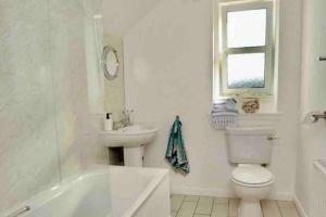 a white bathroom with a toilet and a sink at StAndrews- Sleeps4- FamilyFriendly- NewlyRenovated in St. Andrews +13 photos