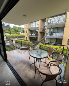 a balcony with a table and chairs and a slide at Alojamiento Familiar para 15 - Con 4 Piscinas - 3 Jacuzzi - Sauna By Molca Travel in La Tebaida