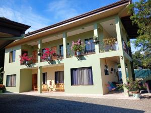 a building with potted plants on the balconies at Hotel La Fiore de Bahia in Uvita