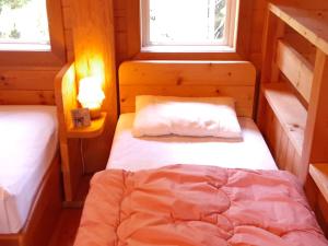 two beds in a room with two windows at seisen-ryo - Vacation STAY 95870 in Gujo