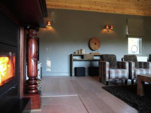a living room with two chairs and a fireplace at Houffalize Forest View Villa in Wibrin +32 photos