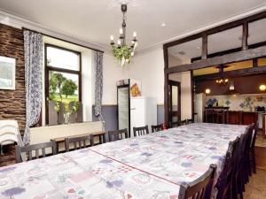 a large dining room with a large table with chairs at Lierneux Forest View Lodge in Lierneux