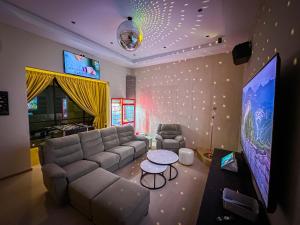 a living room with a couch and a table at Dreamwood Villa Sakeh in Muar