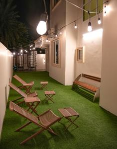 a room with lawn chairs and a couch and lights at Dreamwood Villa Sakeh in Muar