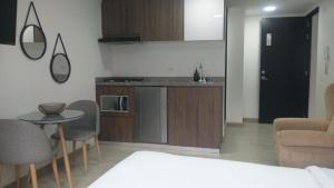 a kitchen and a living room with a table and chairs at Spacio30 in Bogotá