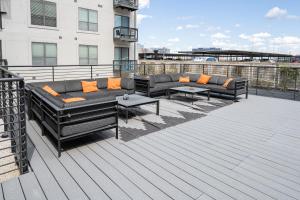 a deck with couches and tables on a building at Spacious Blessed HOME for blessed guests at the Domain in Austin