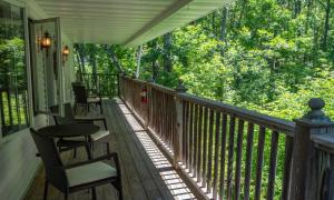a porch with chairs and a table on a house at Wilder Inn in Ephraim