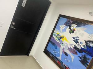 a door with a painting on a wall at Spacio30 in Bogotá