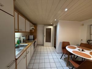 a small kitchen with a table and a table and chairs at Boho & Loft 2 Zimmer Parkplatz in Bad Hersfeld